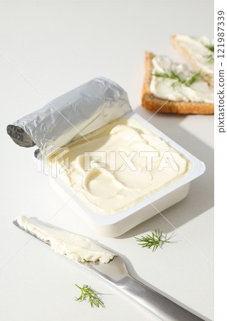 Philadelphia cheese in a plastic container, on a white background. Philadelphia cheese in a plastic container, on a white background. 121987339