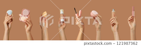 Cosmetic accessories, set of hands with cosmetic accessories on brown background 121987362