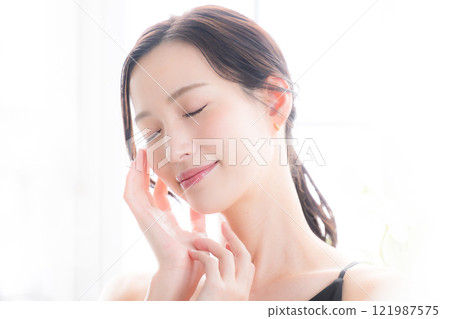 A close-up of a woman with her eyes closed, showing beautiful bare skin, suitable for use in beauty skincare, beauty salons, etc. A close-up of a woman with her eyes closed, showing beautiful bare skin, suitable for use in beauty skincare, beauty salons, etc. 121987575