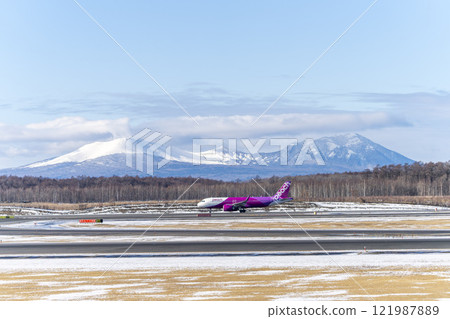 Planes at New Chitose Airport in winter, Mount Tarumae and Mount Fusubushi, Chitose, Hokkaido Planes at New Chitose Airport in winter, Mount Tarumae and Mount Fusubushi, Chitose, Hokkaido 121987889