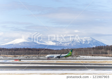 Planes at New Chitose Airport in winter, Mount Tarumae and Mount Fusubushi, Chitose, Hokkaido Planes at New Chitose Airport in winter, Mount Tarumae and Mount Fusubushi, Chitose, Hokkaido 121987903