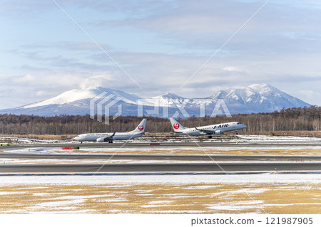 Planes at New Chitose Airport in winter, Mount Tarumae and Mount Fusubushi, Chitose, Hokkaido Planes at New Chitose Airport in winter, Mount Tarumae and Mount Fusubushi, Chitose, Hokkaido 121987905