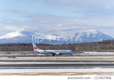 Planes at New Chitose Airport in winter, Mount Tarumae and Mount Fusubushi, Chitose, Hokkaido 121987906
