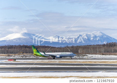 Planes at New Chitose Airport in winter, Mount Tarumae and Mount Fusubushi, Chitose, Hokkaido 121987910