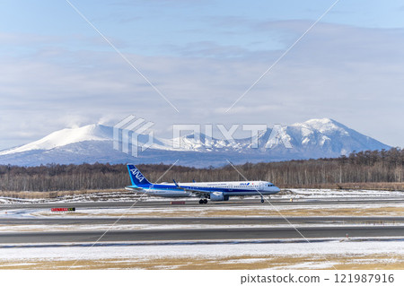 Planes at New Chitose Airport in winter, Mount Tarumae and Mount Fusubushi, Chitose, Hokkaido Planes at New Chitose Airport in winter, Mount Tarumae and Mount Fusubushi, Chitose, Hokkaido 121987916