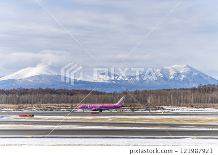 Planes at New Chitose Airport in winter, Mount Tarumae and Mount Fusubushi, Chitose, Hokkaido 121987921