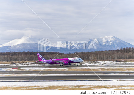Planes at New Chitose Airport in winter, Mount Tarumae and Mount Fusubushi, Chitose, Hokkaido 121987922