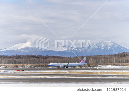 Planes at New Chitose Airport in winter, Mount Tarumae and Mount Fusubushi, Chitose, Hokkaido 121987924