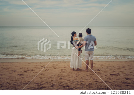 toddler baby girl with her father and mother. happy family on sea beach  in Pattaya, Thailand 121988211