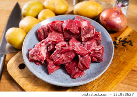 Pieces of raw veal tenderloin and spices, onion, set of products for cooking baked and fried meat 121988627