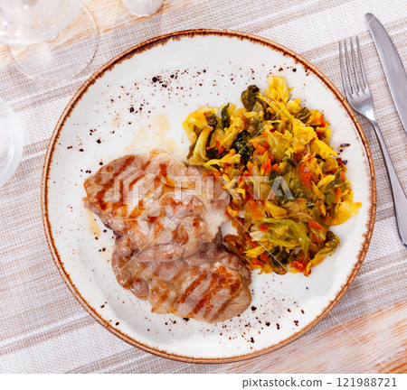 Portion of pork meat with stewed cabbage Portion of pork meat with stewed cabbage 121988721
