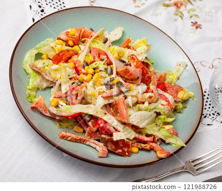 On plate, portion is laid out with pim salad of corn, cabbage, mayonnaise. 121988726