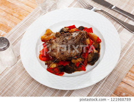 Baked pork chop with sauteed bell pepper, tomatoes, eggplant Baked pork chop with sauteed bell pepper, tomatoes, eggplant 121988789