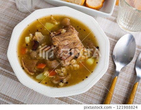 Soup with mushroom, pork, vegetables and pearl barley 121988824