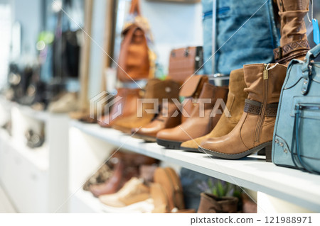 Demi-season suede and leather womens boots on shelves in store 121988971