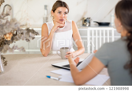 An insurance agent tells young girl the terms of property and life insurance An insurance agent tells young girl the terms of property and life insurance 121988998