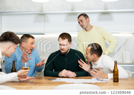 Friends consoling upset worried man reading unexpected medical results Friends consoling upset worried man reading unexpected medical results 121989046