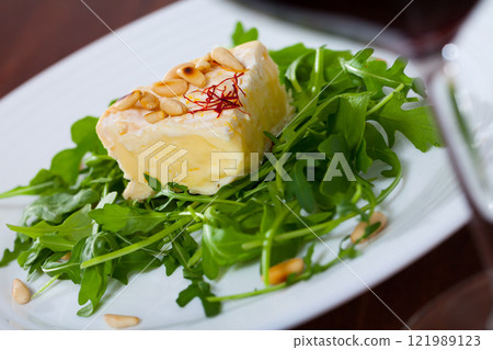 Camembert cheese with pine nuts and arugula Camembert cheese with pine nuts and arugula 121989123