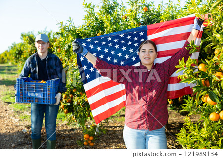 Portrait of a young farmer woman with the flag of USA 121989134