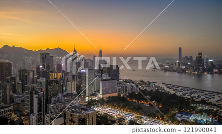 Dec 21 2024 Illuminated City Skyline at Sunset Overlooking Vibrant Harbor hk 121990041