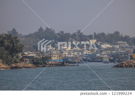 Dec 28 2024 Busy Harbor With Docked Fishing Boats and Scenic Mountain, Cheung Chau 121990224