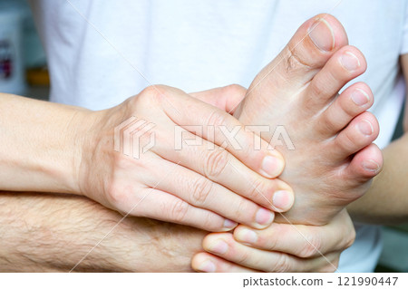 Foot Pain Leg of man sitting on white background and holding he feet and stretch the muscles i .Health care and spa concept. 121990447