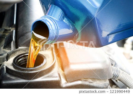 Refueling and pouring oil quality into the engine motor car Transmission and Maintenance Gear .Energy fuel concept. 121990449