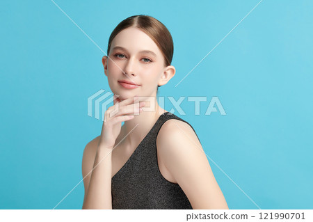 Beautiful young woman with clean fresh skin on blue background, Face care, Facial treatment, Cosmetology, beauty and spa, women portrait. 121990701