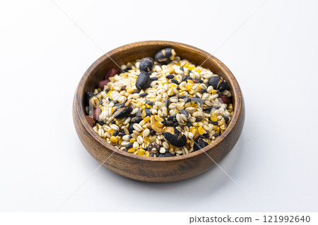 Sixteen grain rice served on a wooden plate on a white background 121992640