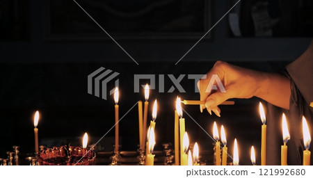Lighting Candles Symbolizing Deep Faith and Spiritual Devotion in a Sacred Space Creates Atmosphere for Reflection and Connection With Higher Power, Enhancing Prayer and Ritual Experience Lighting Candles Symbolizing Deep Faith and Spiritual Devotion in a Sacred Space Creates Atmosphere for Reflection and Connection With Higher Power, Enhancing Prayer and Ritual Experience 121992680