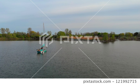Yacht on still lake symbolizes ultimate freedom and solitude. Drone view private sail away from crowds, where one can truly feel harmony with nature and peaceful surroundings. Yacht vacation concept Yacht on still lake symbolizes ultimate freedom and solitude. Drone view private sail away from crowds, where one can truly feel harmony with nature and peaceful surroundings. Yacht vacation concept 121992715