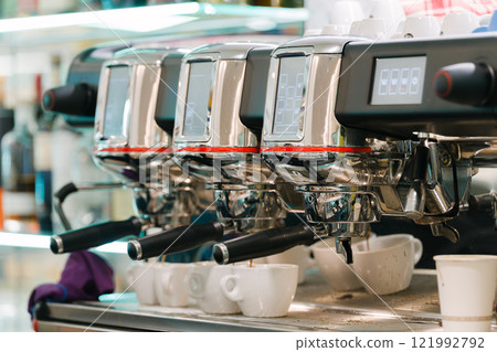Espresso machine and cups lined up in a cafe Espresso machine and cups lined up in a cafe 121992792