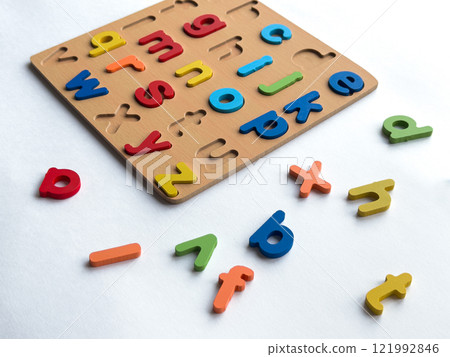 Colorful wooden alphabet puzzle for early childhood learning and development Colorful wooden alphabet puzzle for early childhood learning and development 121992846