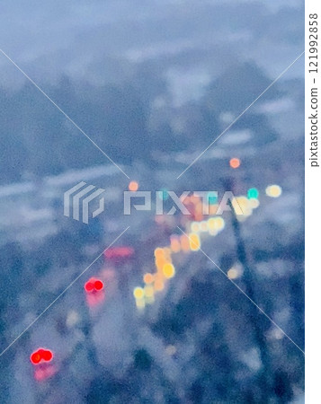 Rainbow-colored car lights shining on the snow 121992858
