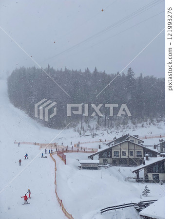 Snowy Ski Slope with Ski Lifts and Trees 121993276