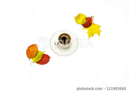 Autumn leaves and a cup of coffee with a saucer on a white background Autumn leaves and a cup of coffee with a saucer on a white background 121993688