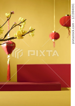 An idea for Lunar New Year. Frontal view of two red cylindrical pedestals for showing a product against a golden backdrop. Chinese lanterns with red and yellow apricot blossoms as decorations. An idea for Lunar New Year. Frontal view of two red cylindrical pedestals for showing a product against a golden backdrop. Chinese lanterns with red and yellow apricot blossoms as decorations. 121994091