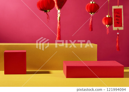 The Chinese New Year product ad image. A product is positioned on empty cylindrical pedestals against a crimson backdrop, standing on a golden surface. decorated with crimson lanterns and calligraphy. The Chinese New Year product ad image. A product is positioned on empty cylindrical pedestals against a crimson backdrop, standing on a golden surface. decorated with crimson lanterns and calligraphy. 121994094