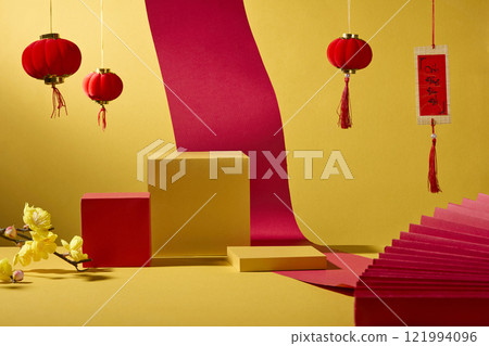 Festive Lunar New Year scene with some empty podiums, paper fans, lanterns, a red paper roll, and yellow blooming branches, creating a minimalist product display against a golden background. 121994096