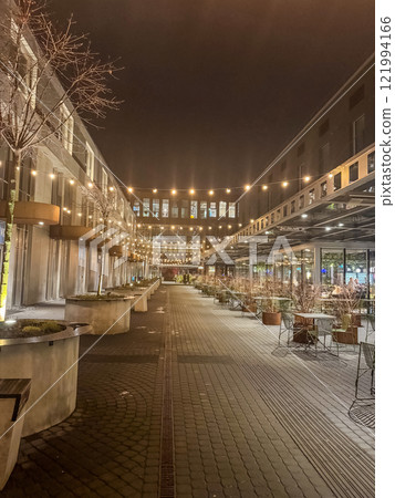 A quiet evening at an outdoor dining area, bathed in soft light. High quality photo 121994166