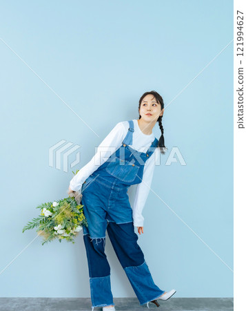 Portrait of a woman in denim overalls 121994627