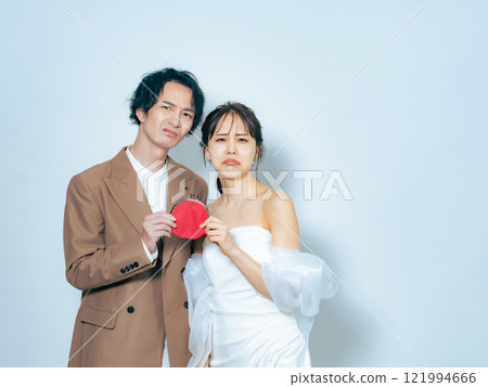 Bride and groom worried about their wallets Bride and groom worried about their wallets 121994666