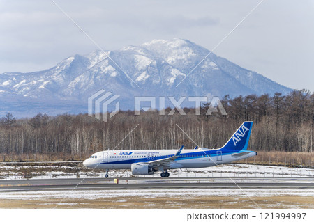 Planes at New Chitose Airport and Mount Fusubushi in winter, Chitose, Hokkaido 121994997