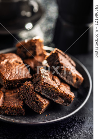 Homemade chocolate brownies on plate on black table. 121996565