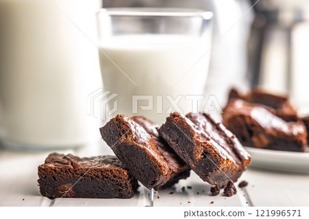 Homemade chocolate brownies on white table. Homemade chocolate brownies on white table. 121996571