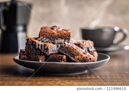 Homemade chocolate brownies on plate on wooden table. Homemade chocolate brownies on plate on wooden table. 121996618