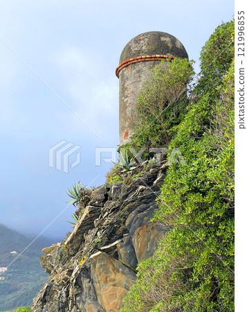 Old stone tower and path near sea in fall in Italy. Municipality Moneglia, Liguria region. View from mountain. Old stone tower and path near sea in fall in Italy. Municipality Moneglia, Liguria region. View from mountain. 121996855