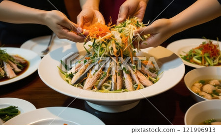 Group tossing traditional Asian salad together  Group tossing traditional Asian salad together  121996913
