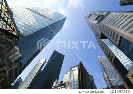 Low-angle building view of the modern office skyscrapers in the financial district of Raffles Place, Singapore. Low-angle building view of the modern office skyscrapers in the financial district of Raffles Place, Singapore. 121997210