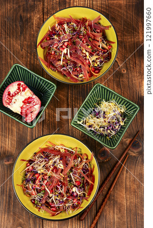 Sprouts and pomegranate salad. 121997660